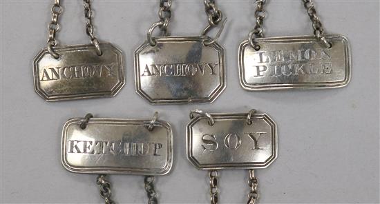 Five George III and later silver sauce labels;